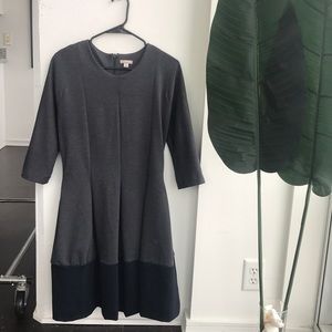 Dark grey A-line dress with navy blue trim.